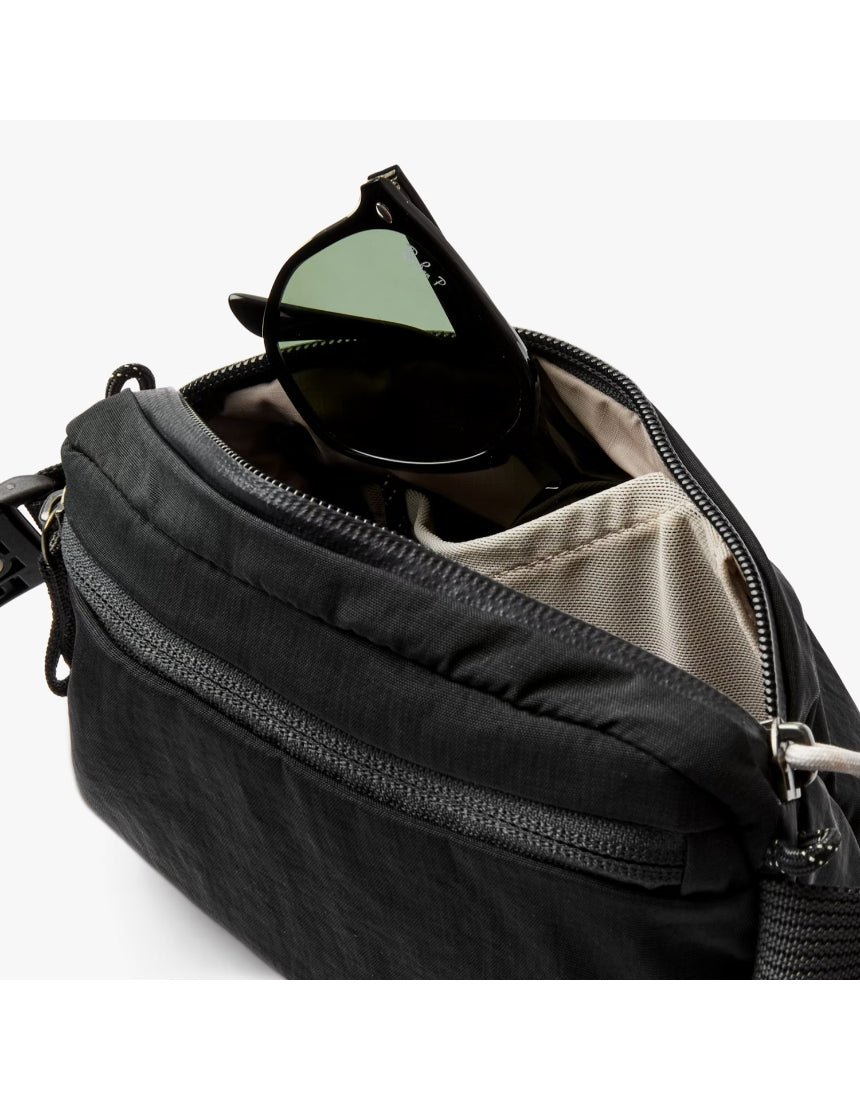 Black Bellroy Lite Belt Bag with adjustable strap and multiple compartments, designed for convenient everyday carrying.