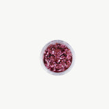 Oh Flossy biodegradable pink glitter mix in a clear container, showcasing sparkling, eco-friendly glitter for craft and beauty uses.