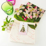 Petal & Pins floral pure linen tea towel with apple blossom design, showcasing a vibrant, detailed floral pattern on soft linen fabric.