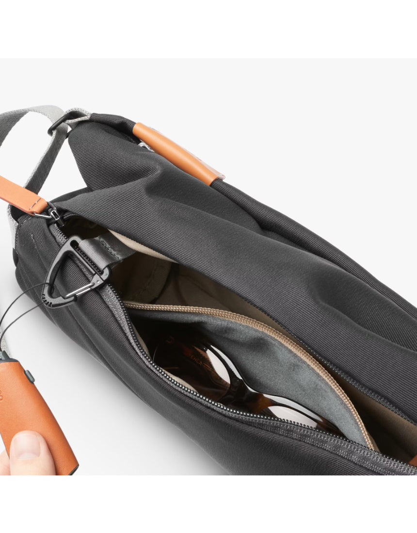 Bellroy Slate sling bag with adjustable strap and compact design, shown in a close-up image.