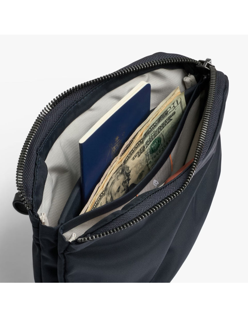Bellroy Tokyo Side Bag in navy, a stylish crossbody bag with multiple compartments and adjustable strap, designed for everyday use.