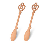 Fisura Castle Key wooden spoon set of 2, handcrafted kitchen utensils with carved castle key design, natural wood finish.