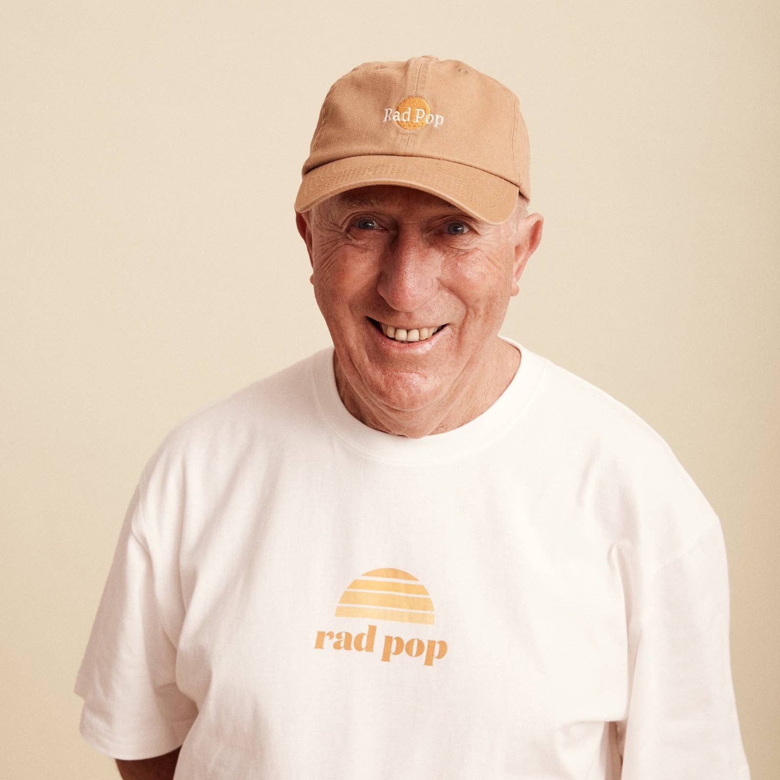 Banabae Rad Pop Washed Baseball Cap in desert sand, showing the washed fabric texture and curved brim on a casual cap.