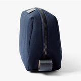 Bellroy navy toiletry kit with zipper closure, compact design, and multiple compartments for travel essentials.