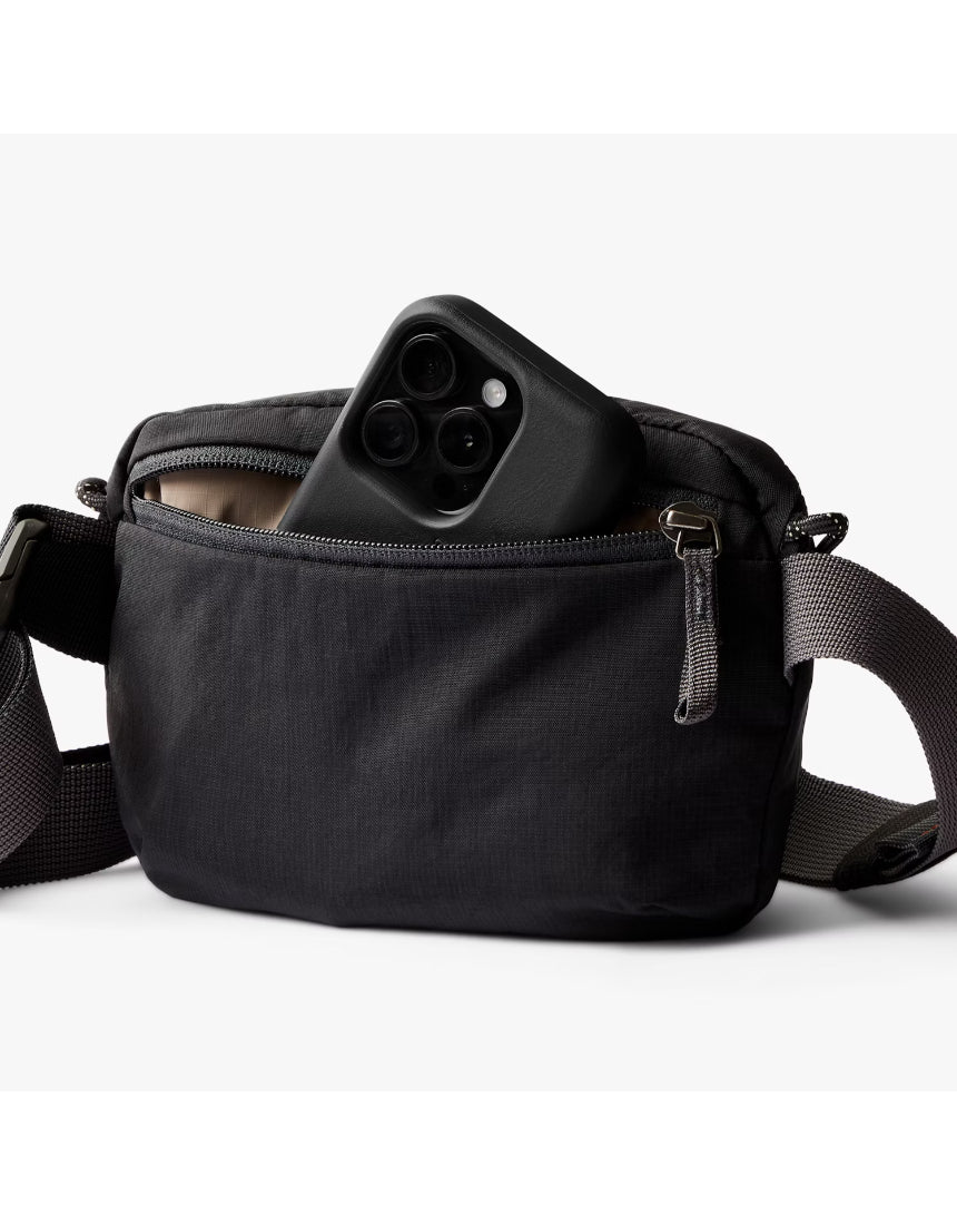 Black Bellroy Lite Belt Bag with adjustable strap and multiple compartments, designed for convenient everyday carry.