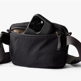 Black Bellroy Lite Belt Bag with adjustable strap and multiple compartments, designed for convenient everyday carry.