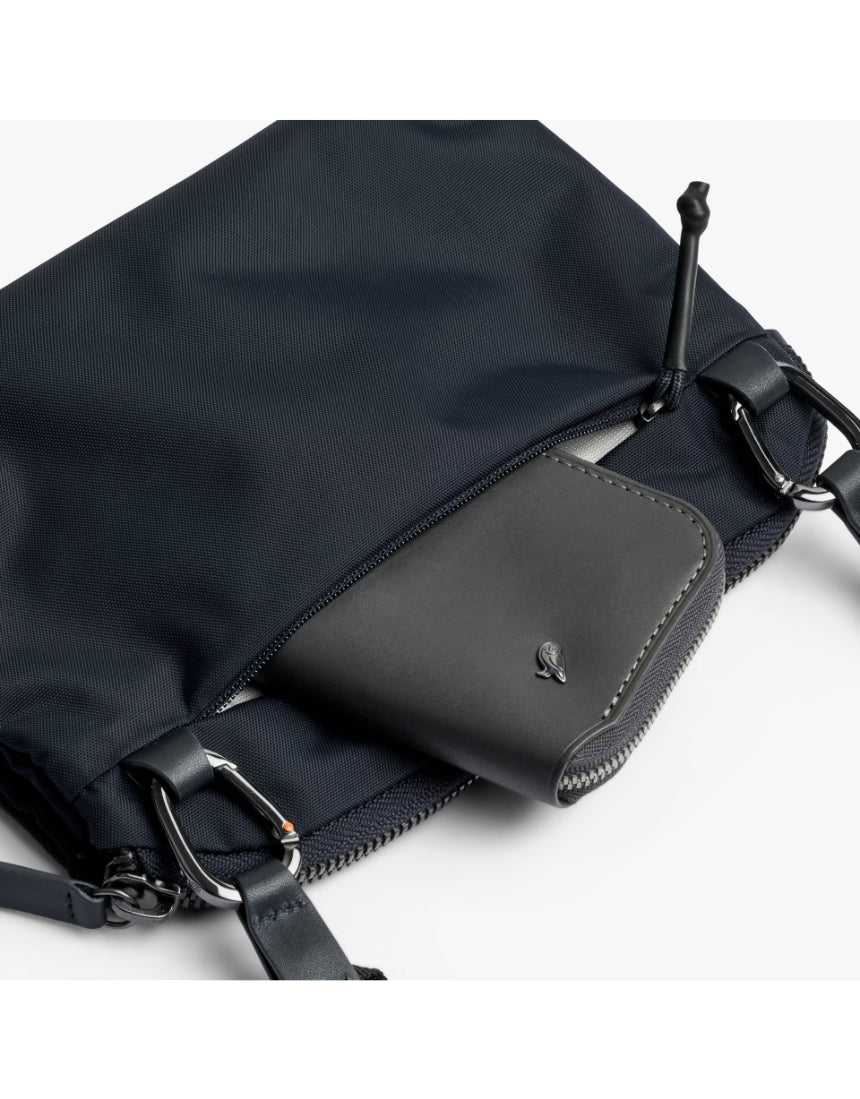 Bellroy Tokyo Side Bag in navy, a stylish crossbody bag with sleek design, adjustable strap, and multiple compartments.