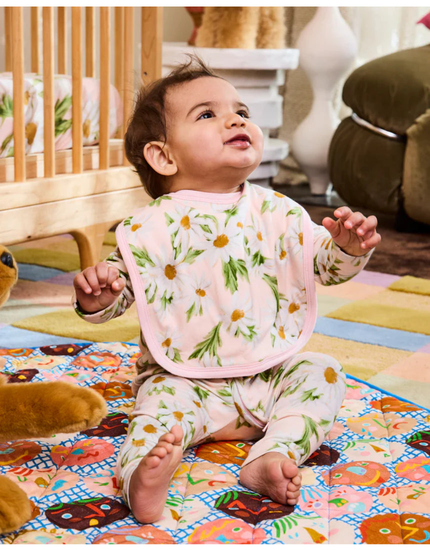 Kip & Co Sweet Daisy cotton baby bib with colorful daisy pattern, soft fabric, and adjustable neck closure.