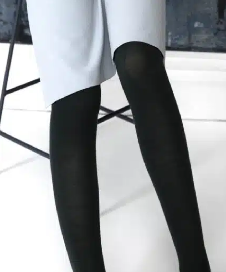 Black Merino wool tights by Tightology, close-up of smooth, snug fit fabric showcasing the luxurious texture and elastic waistband.