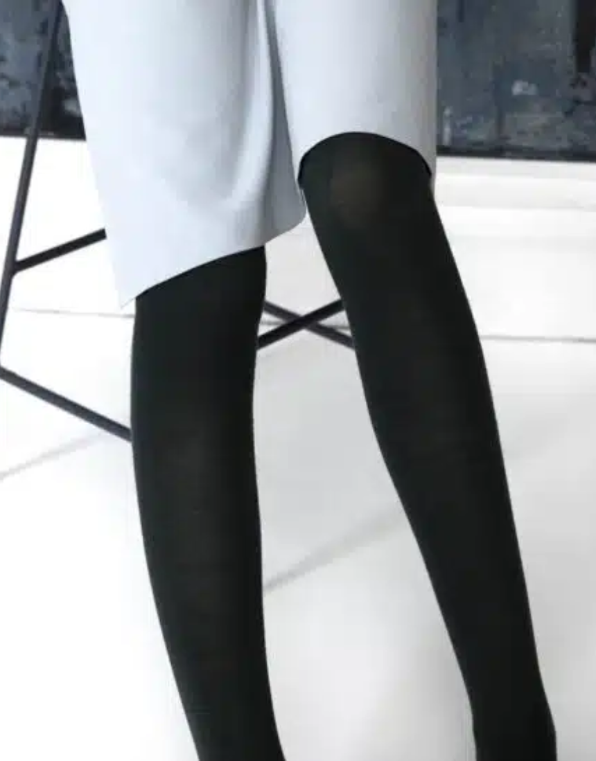 Black Merino wool tights by Tightology, close-up of smooth, snug fit fabric showcasing the luxurious texture and elastic waistband.