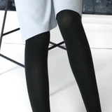 Black Merino wool tights by Tightology, close-up of smooth, snug fit fabric showcasing the luxurious texture and elastic waistband.