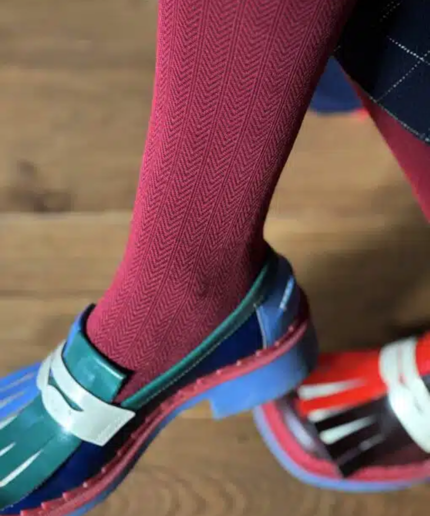 Tightology Martini Crimson Wool Tights displayed on a model, showcasing their vibrant red color and fitted style.