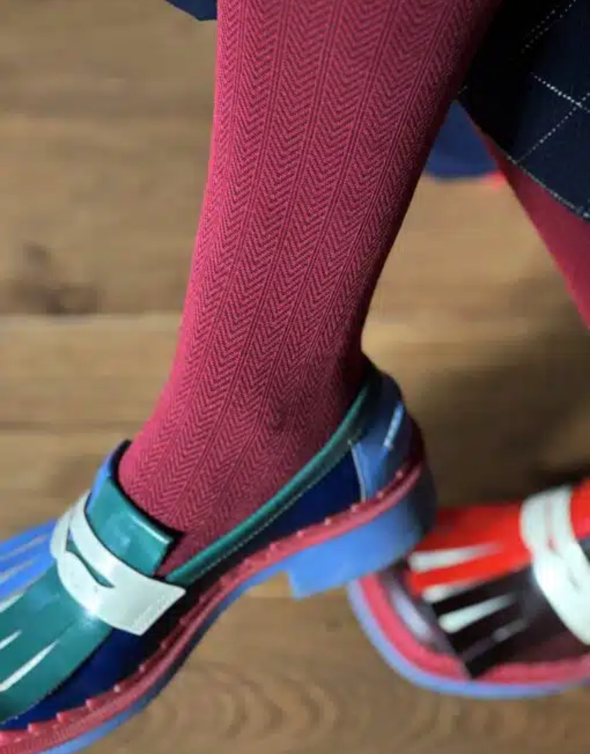 Tightology Martini Crimson Wool Tights displayed on a model, showcasing their vibrant red color and fitted style.