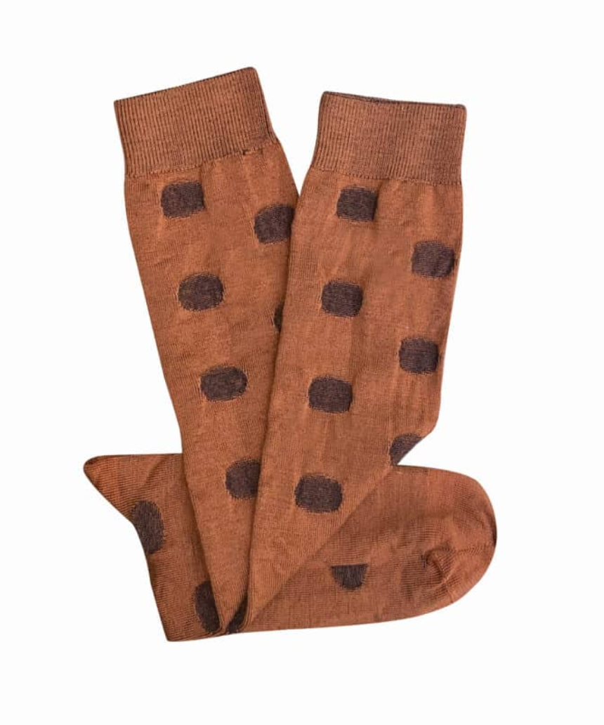 Tightology Yayoi Paprika Merino Wool Socks featuring bright red and orange patterns and soft wool texture.