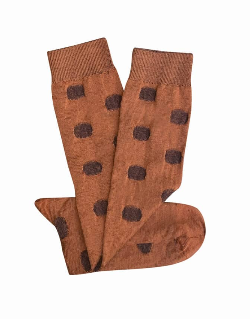 Tightology Yayoi Paprika Merino Wool Socks featuring bright red and orange patterns and soft wool texture.