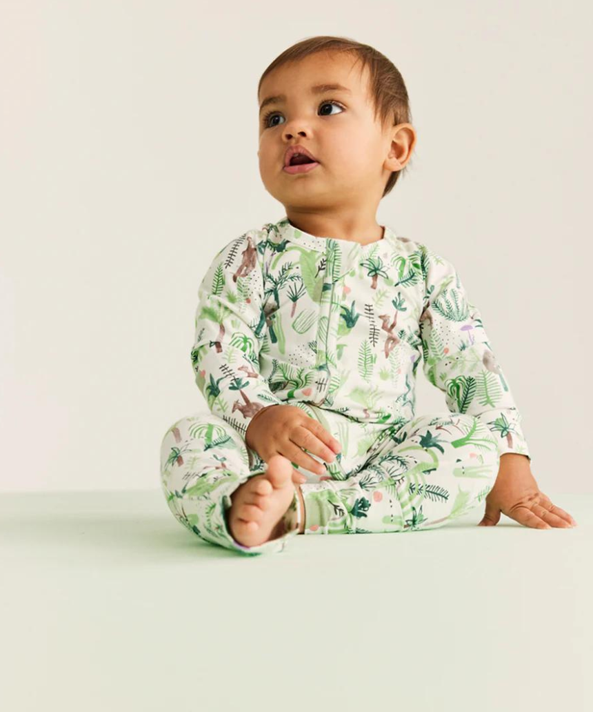 Baby Halcyon Nights Fern Gully long sleeve zip suit featuring a leafy green fern pattern on soft fabric.