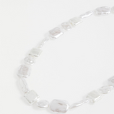 Elk Sota necklace with silver pendant featuring intricate design, displayed on a neutral background.