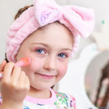 Kids' Oh Flossy cosmetic headband with pink and white polka dots, made of soft fabric for comfortable wear.