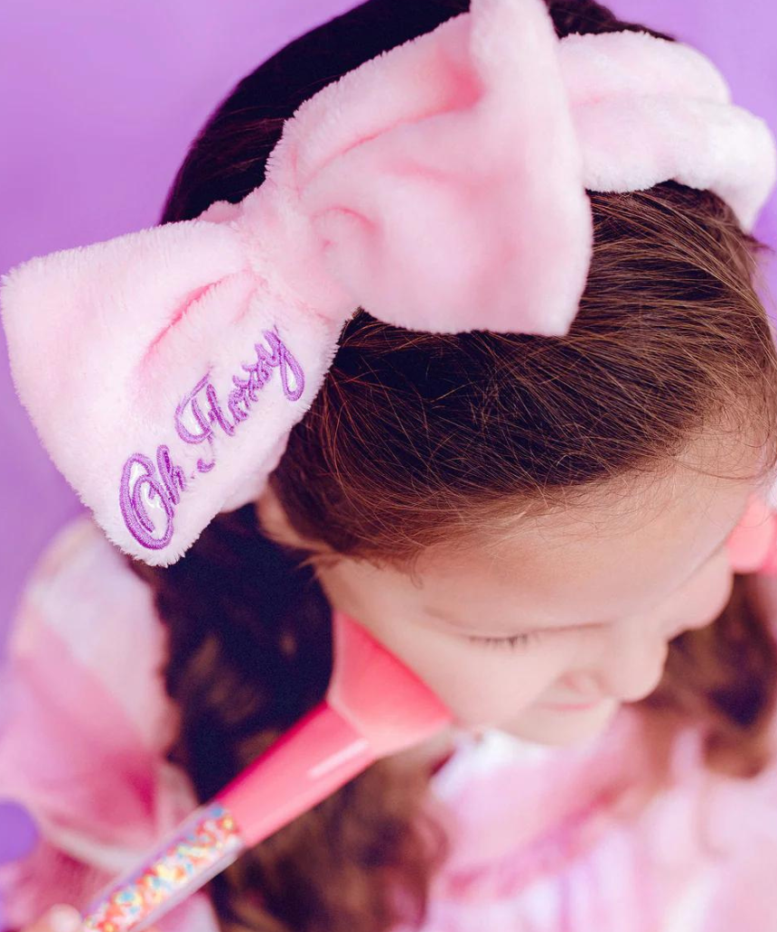 Kids' Oh Flossy cosmetic headband with soft fabric and colorful design, perfect for styling and comfort.