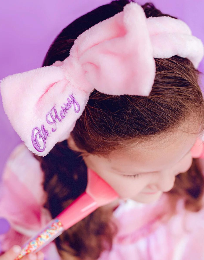 Kids' Oh Flossy cosmetic headband with soft fabric and colorful design, perfect for styling and comfort.