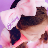 Kids' Oh Flossy cosmetic headband with soft fabric and colorful design, perfect for styling and comfort.