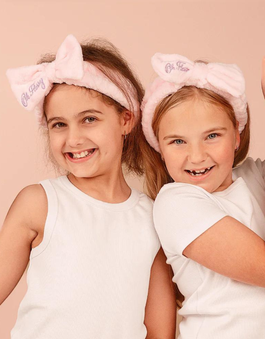 Kids cosmetic headband by Oh Flossy with colorful, soft fabric and playful design for children’s hair accessories.