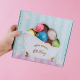 Colorful Oh Flossy Kids Mini Bath Bombs in various shapes and bright hues, perfect for fun bath time for children.