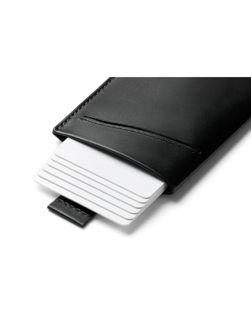 Bellroy Card Sleeve 2nd Edition in black leather holding several credit and ID cards, compact wallet design.