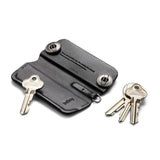 Black Bellroy Key Cover Plus 3rd Edition holding multiple keys on a keychain, made of sleek leather with subtle branding.