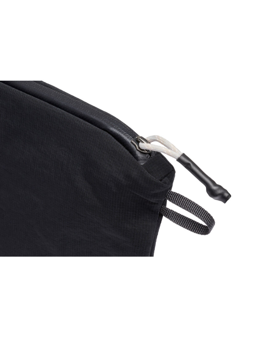 Bellroy Light Pouch Duo in black, compact leather accessory with two zippered compartments for organizing essentials.