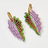 Tan and lilac Martha Jean Big Leaf earrings featuring large leaf-shaped design on silver hooks.