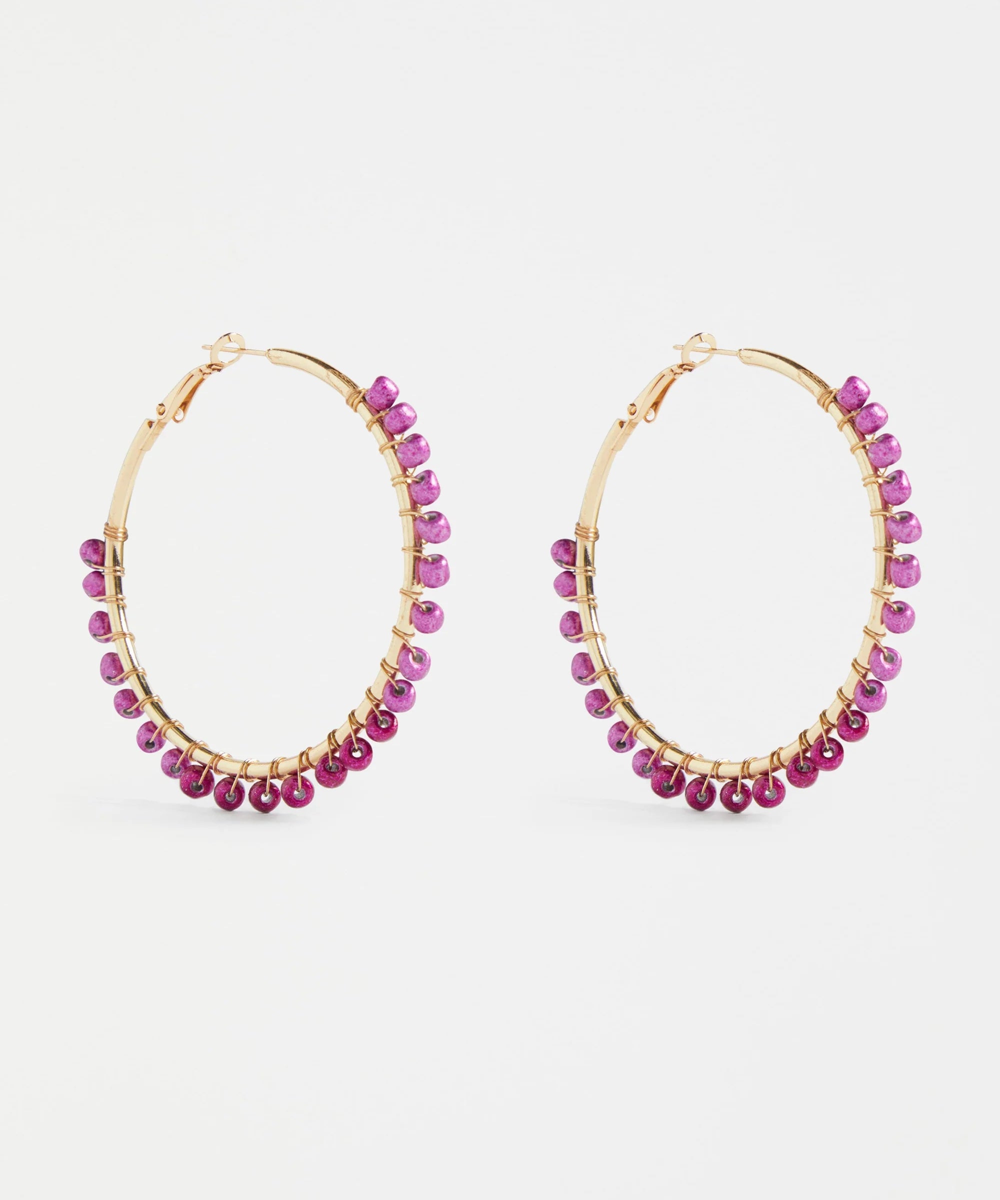 Elk Oko Hoop Earring in Mulberry color, gold-toned metal with a sleek, minimalist hoop design, close-up on a white background.