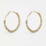 Elk Oko Hoop Earring in ecru color, showcasing a stylish, lightweight hoop design perfect for everyday wear