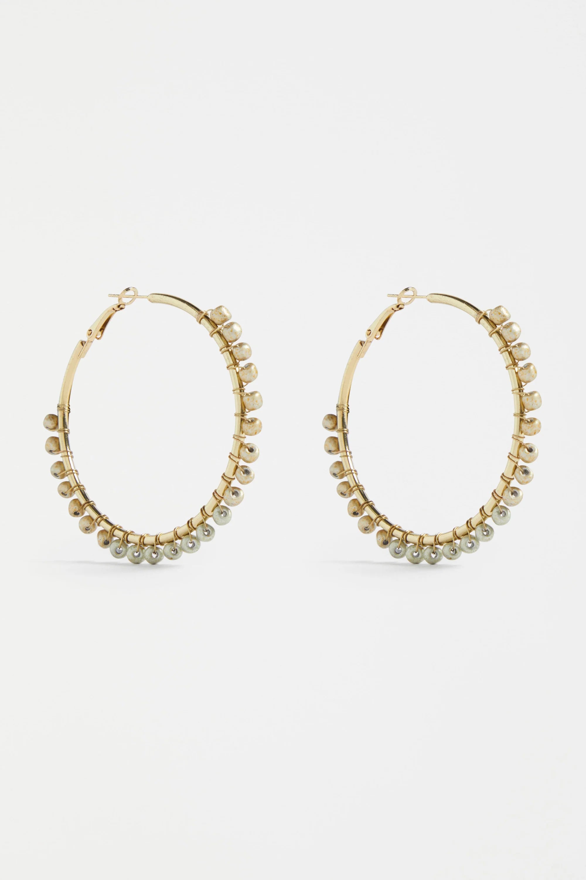 Elk Oko Hoop Earring in ecru color, showcasing a stylish, lightweight hoop design perfect for everyday wear