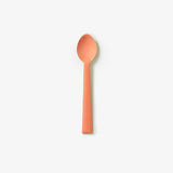 Bonnie and Neil enamel teaspoon in peach from a cutlery set, featuring a smooth ceramic handle and vintage-inspired design.