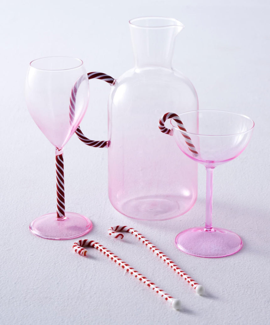 Kip & Co candy cane water jug with red and white striped design, large handle, and glossy finish for serving beverages.