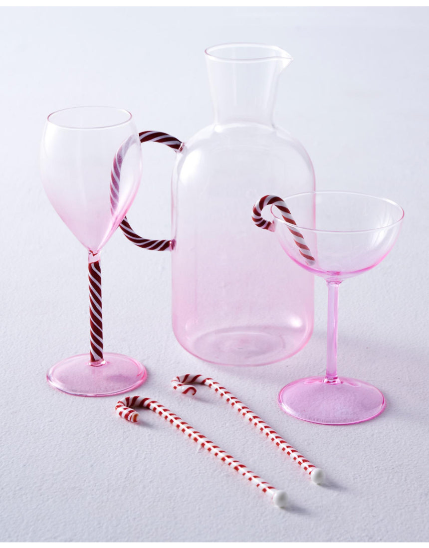 Kip & Co candy cane water jug with red and white striped design, large handle, and glossy finish for serving beverages.