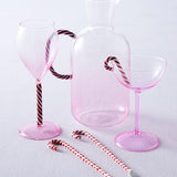 Kip & Co candy cane water jug with red and white striped design, large handle, and glossy finish for serving beverages.