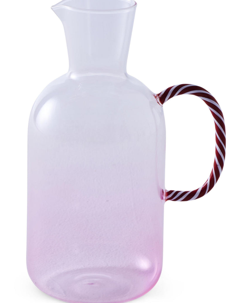 Kip & Co candy cane water jug with red and white striped design, large ceramic pitcher for beverages on a kitchen counter.