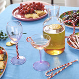 Kip & Co candy cane water jug with red and white striped design, large glass container for serving beverages.