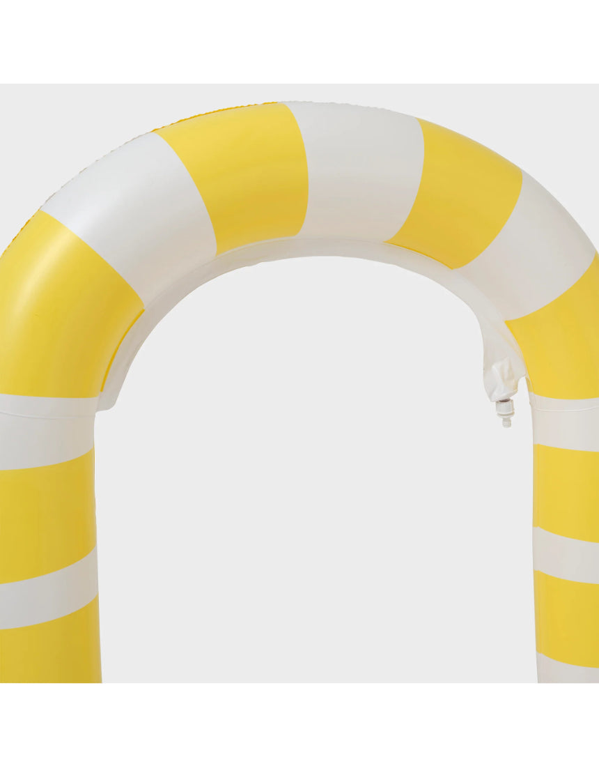 Sunnylife giant snake sprinkler watering garden with colorful, flexible snake-shaped sprinkler in outdoor yard scene.
