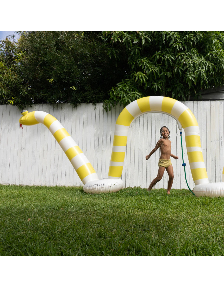 Sunnylife giant snake sprinkler spraying water, colorful outdoor garden sprinkler for kids and summer fun.