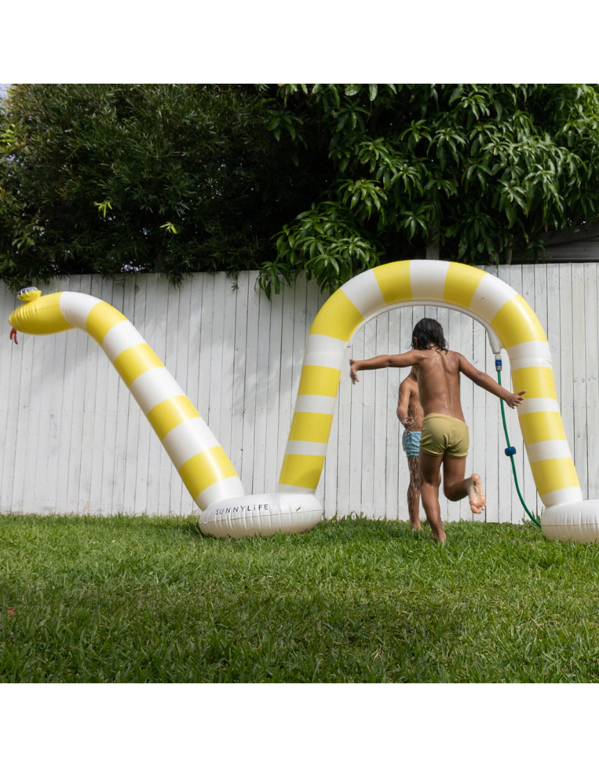Sunnylife Snake Giant Sprinkler spread out on grass, colorful garden sprinkler in snake shape for outdoor fun and watering.