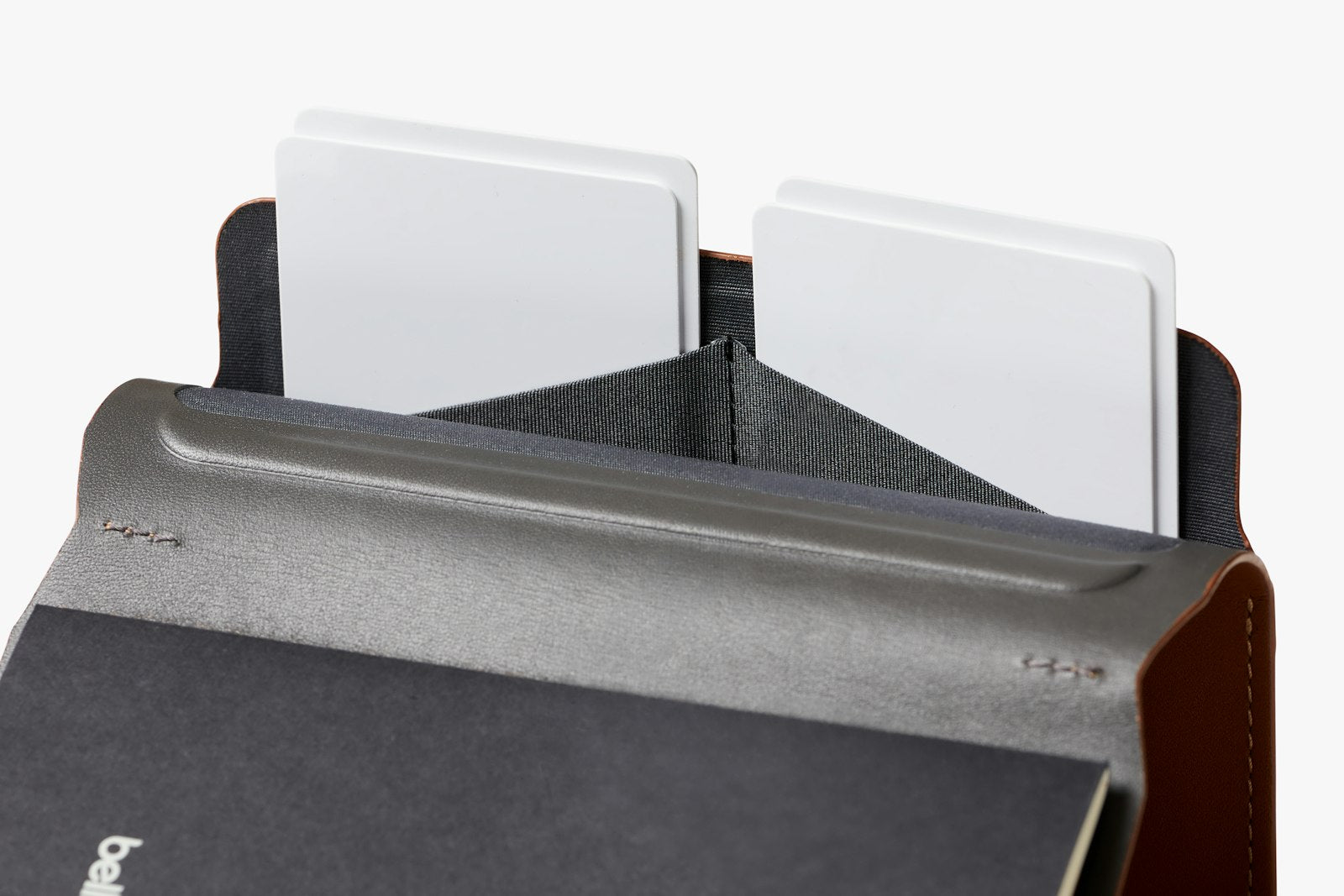 Bellroy caramel notebook cover with sleek leather exterior and embossed logo, designed to protect and organize notebooks.