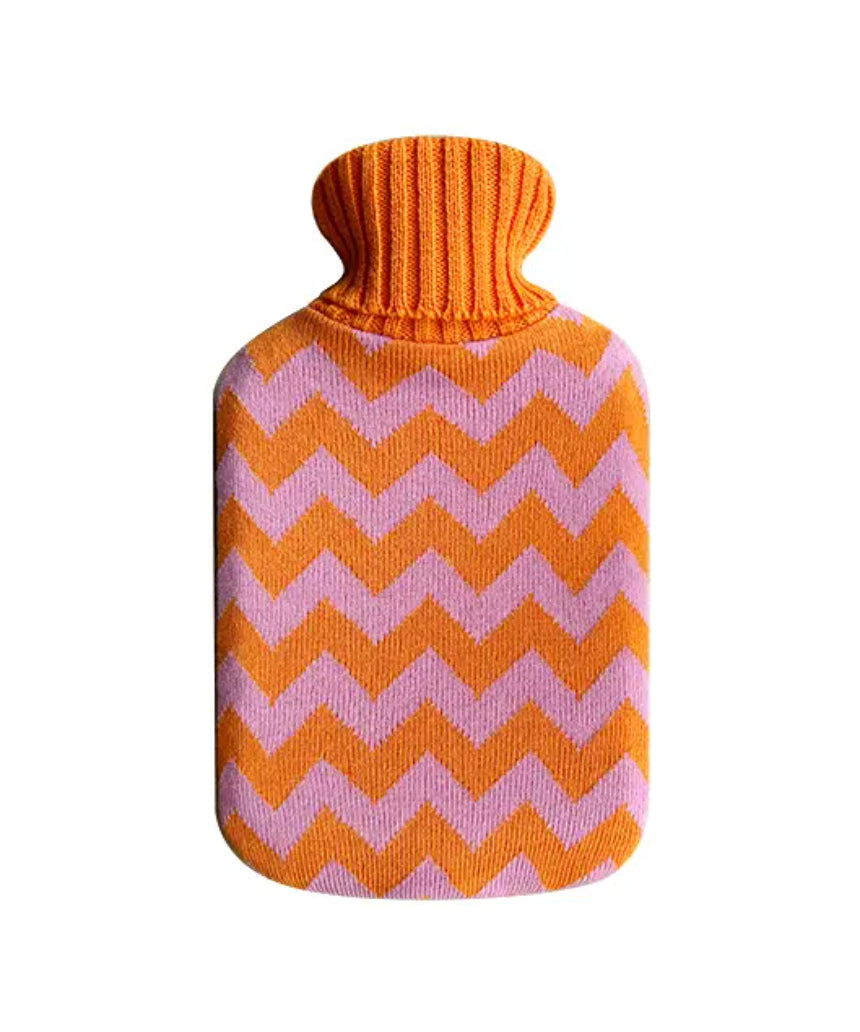 Casa Rolio hot water bottle with orange tangerine cover, soft fabric and flexible rubber body for soothing warmth.
