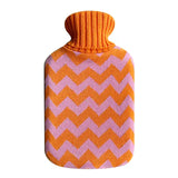 Casa Rolio hot water bottle with orange tangerine cover, soft fabric and flexible rubber body for soothing warmth.