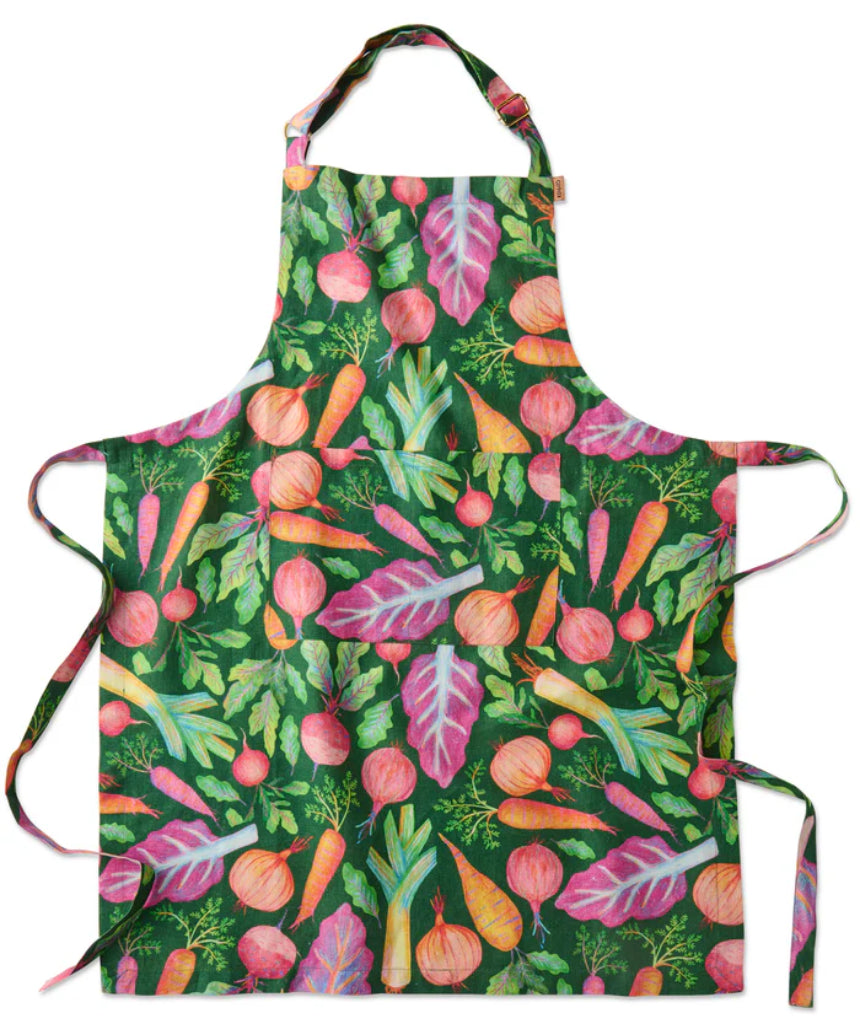 Kip & Co veggie soup apron with colorful vegetable print, adjustable neck strap, and front pocket, made for cooking and kitchen use.