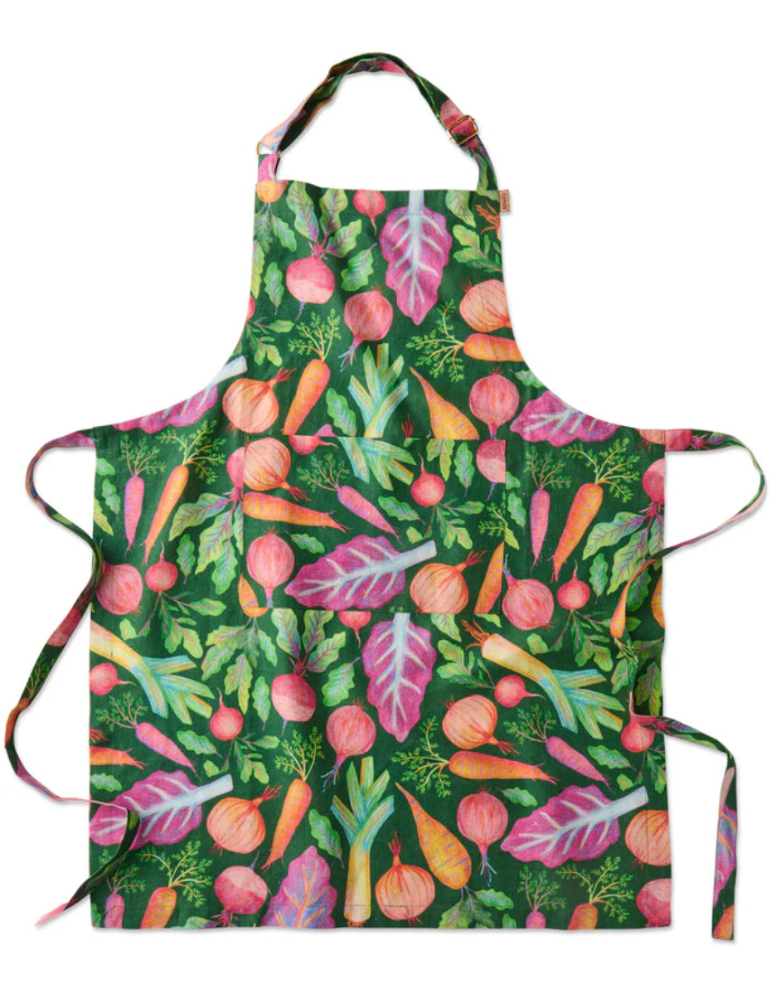 Kip & Co veggie soup apron with colorful vegetable print, adjustable neck strap, and front pocket, made for cooking and kitchen use.