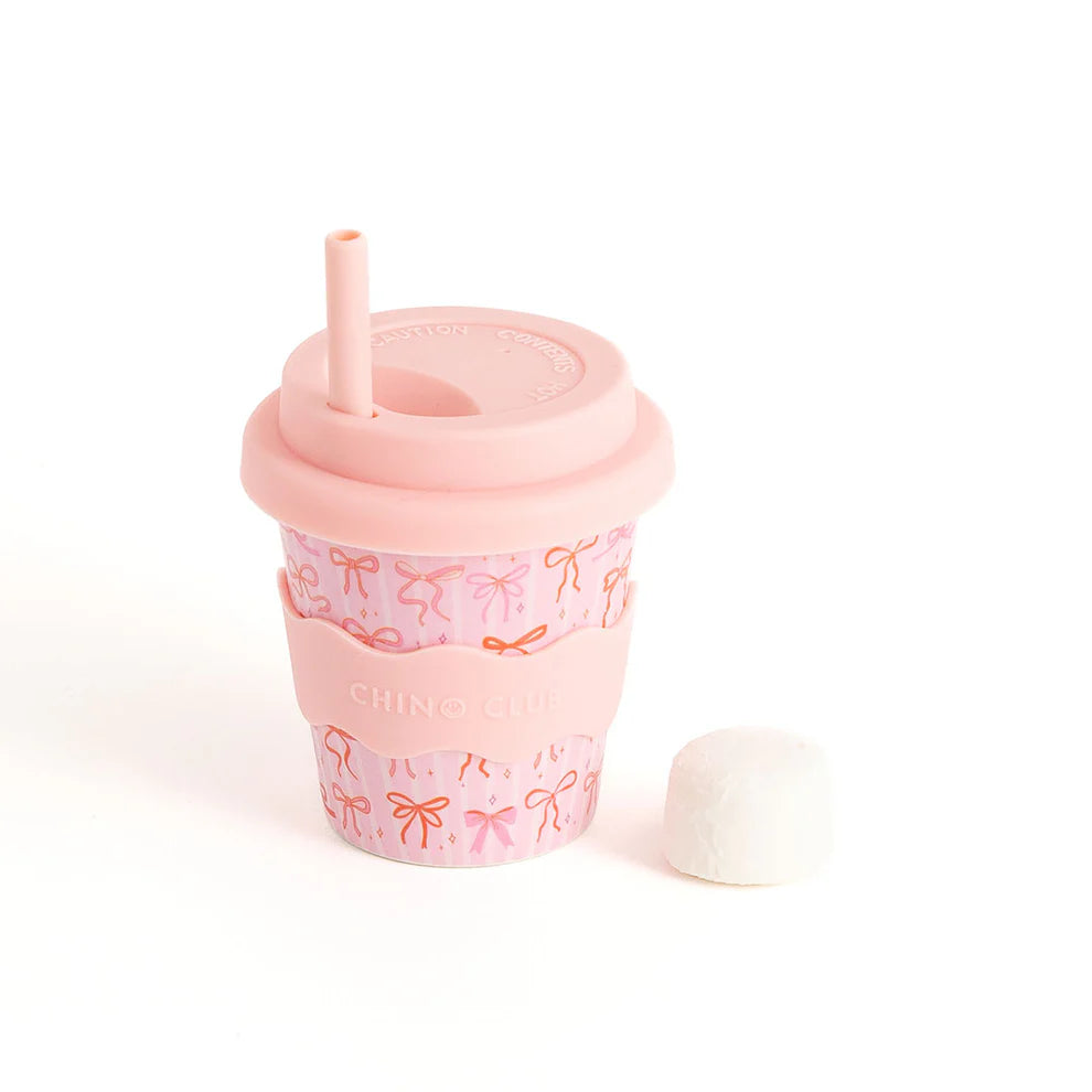 Kids Chino Club Bows Baby Chino Cup 4oz with colorful bow design, small kids' cup for beverages, suitable for young children.