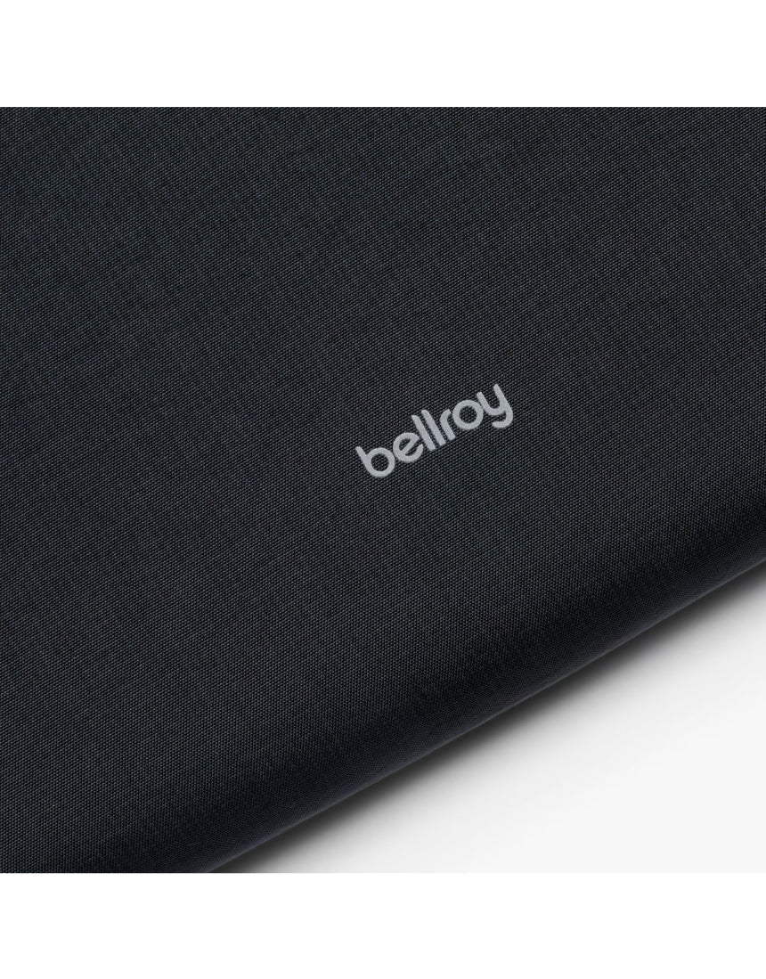 Black Bellroy Lite Laptop Sleeve for 16-inch laptops, shown with the sleeve open revealing a sleek interior.
